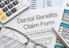 Close up a Dental benefits claim form with calculator and pen