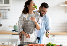 millennial couple preparing healthy vegetarian salad